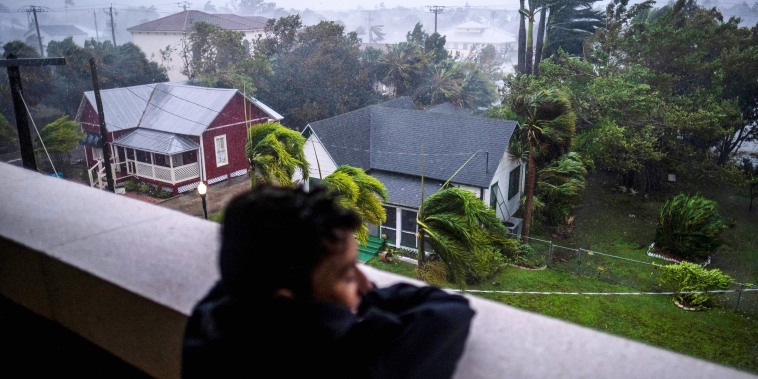 A child looks out at Hurricane Ian