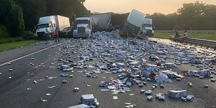 In this photo provided by Florida Highway Patrol, cases of Coors Light beer are strewn across a highway after two semitrailers collided on a Florida highway on Wednesday, Sept. 21, 2022, near Brooksville, Fla. (Florida Highway Patrol via AP)