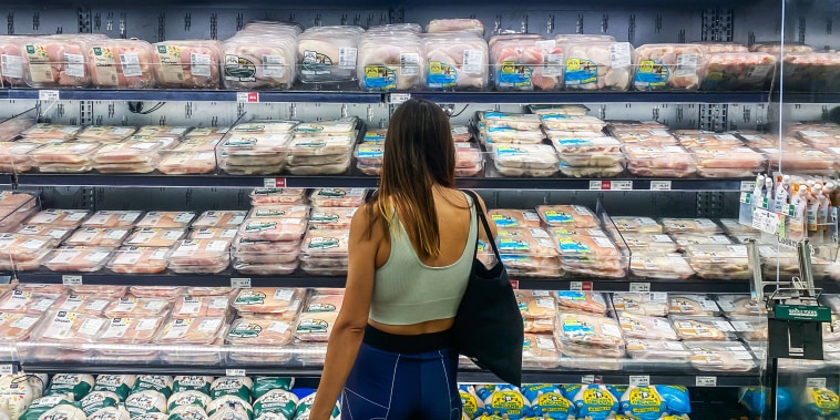 A customer shops for chicken inside a supermarket in Santa Monica, Calif.