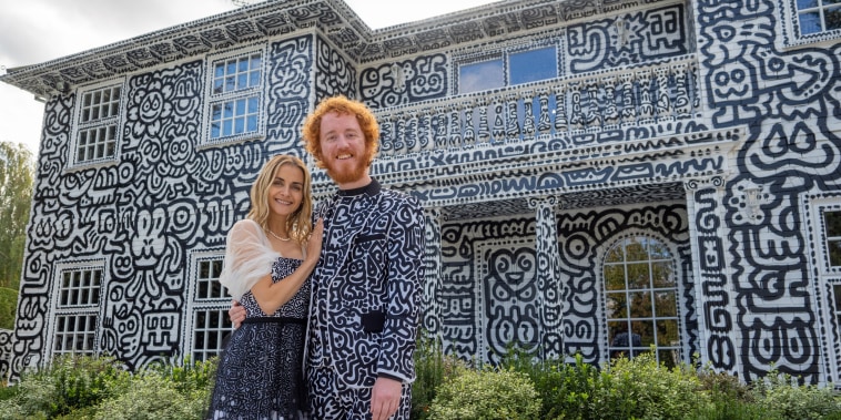 Artist Sam Cox and his wife, Alena, outside their house.