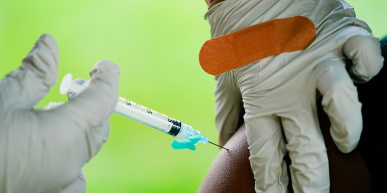 A health worker administers a dose of a Pfizer COVID-19 vaccine in Reading, Pa.