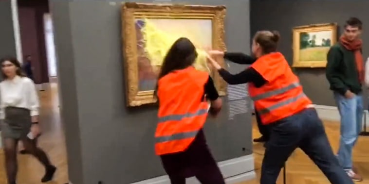 Climate activists throw mashed potatoes on a Monet painting at the Barberini Museum in Potsdam, Germany, on Oct. 23, 2022.