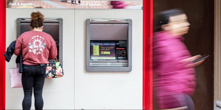 A customer uses an automated teller machine at a bank in San Francisco.