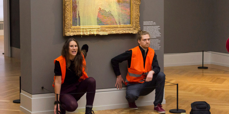 Climate protesters glue their hands below a Monet painting 
