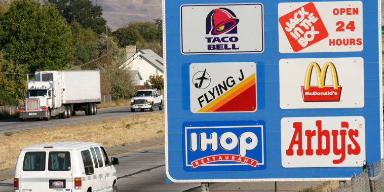 Economy USA, FAST FOOD: sign at the Interstate gives information about restaurants coming at the next exit