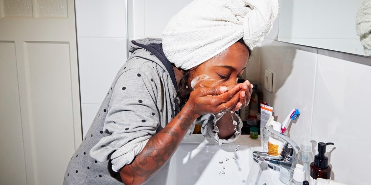 Woman washes her face