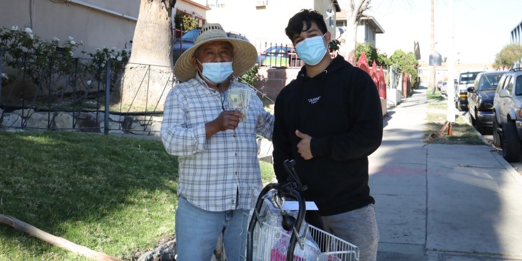 Jesús Morales poses with one of the 90+ food vendors he's been able to support through crowdfunding on TikTok.