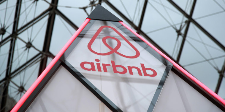 The Airbnb logo is seen on a little mini pyramid under the glass Pyramid of the Louvre museum in Paris in 2019. 