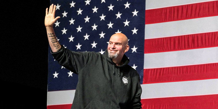 Image: Pennsylvania Democratic Senatorial candidate John Fetterman waves as he arrives onstage at a watch party during the midterm elections at Stage AE in Pittsburgh, Pa., on Nov. 8, 2022.