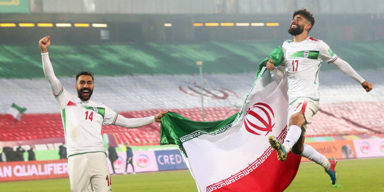 Saman Ghoddos, left, and Ali Gholizadeh of Iran celebrate after the FIFA World Cup Qualifier match between Iran and Iraq at Azadi Stadium in Tehran, Iran, on Jan. 27, 2022.