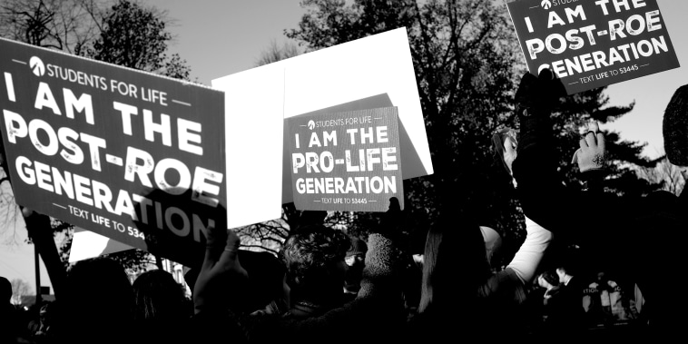Image: Anti-abortion demonstrators outside the Supreme Court  walking with signs that read,"Students for Life, I am the Post-Roe Generation".