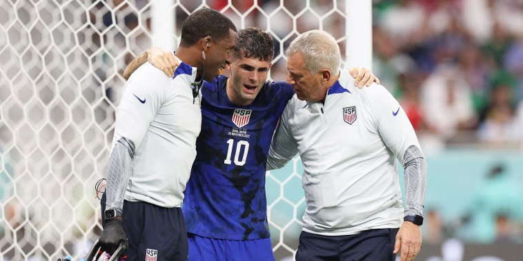 USA's forward #10 Christian Pulisic receives medical attention after injuring himself while scoring his team's first goal during the Qatar 2022 World Cup Group B football match between Iran and USA at the Al-Thumama Stadium in Doha on November 29, 2022.