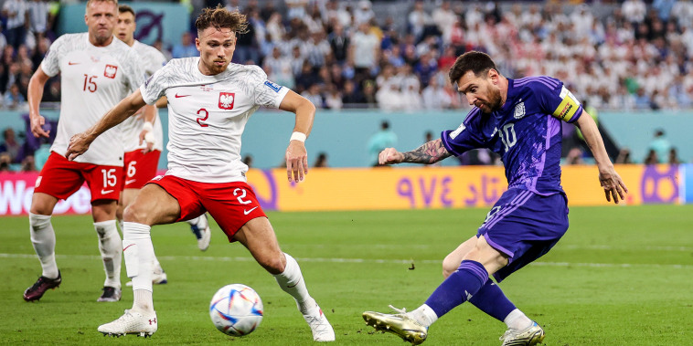 Image: Lionel Messi of Argentina shoots the ball against Matty Cash of Poland during the FIFA World Cup Qatar 2022 Group C match between Poland and Argentina at Stadium 974 on Nov. 30, 2022 in Doha, Qatar.