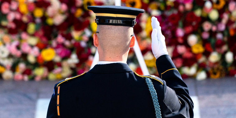 A tomb guard of the 3rd U.S. Infantry Regiment salutes before a centennial ceremony.