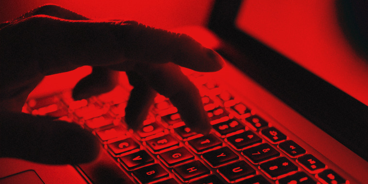 Hand typing on keyboard.