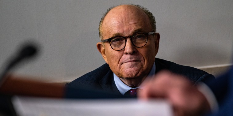 Rudy Giuliani attends a news briefing at The White House