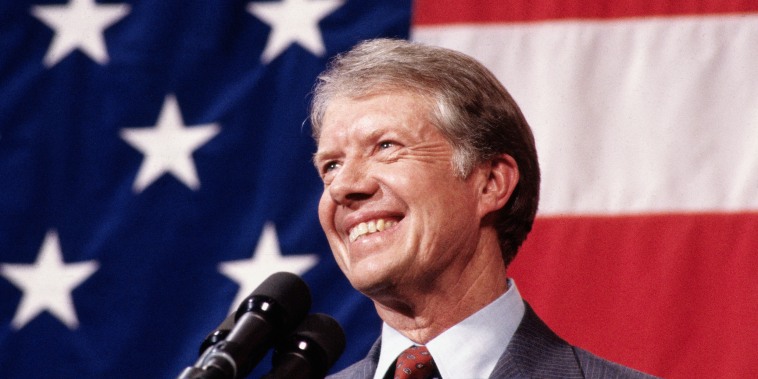 Image: Closeup of President Jimmy Carter at the podium with the American flag in the background.