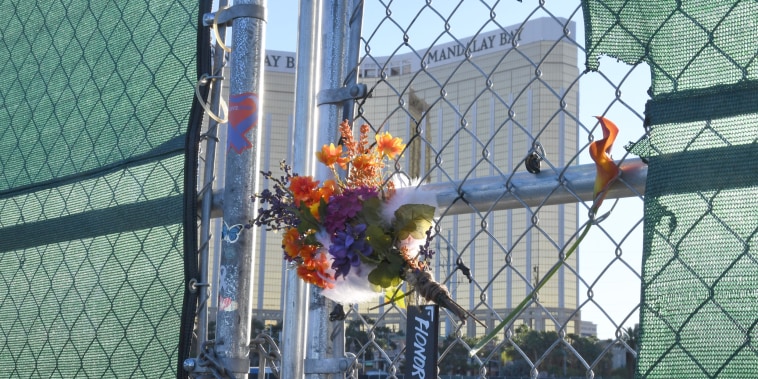 Flowers and a sign reading "HONOR 58" hang on a fence outside the Las Vegas Village across from Mandalay Bay Resort and Casino on Sept. 30, 2019 in Las Vegas.