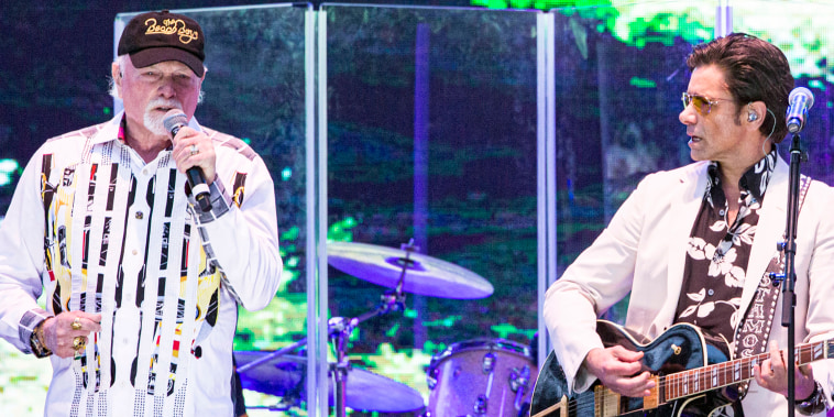 Musicians Mike Love (R) and John Stamos of The Beach Boys on stage.