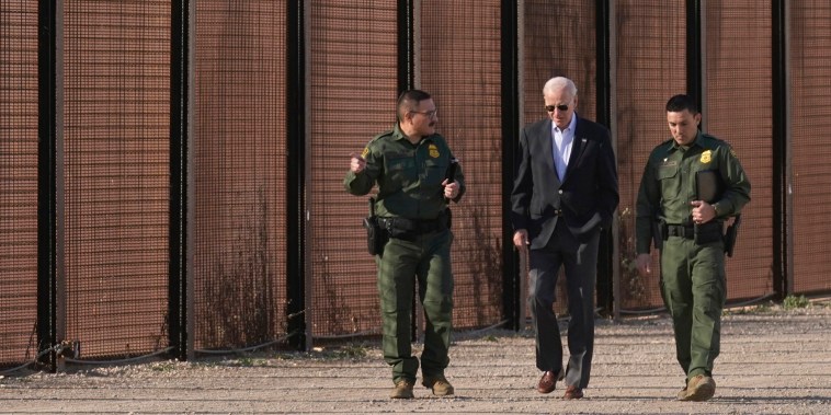 Joe Biden walks with U.S. Border Patrol agents along a stretch of the U.S.-Mexico border in El Paso, Texas