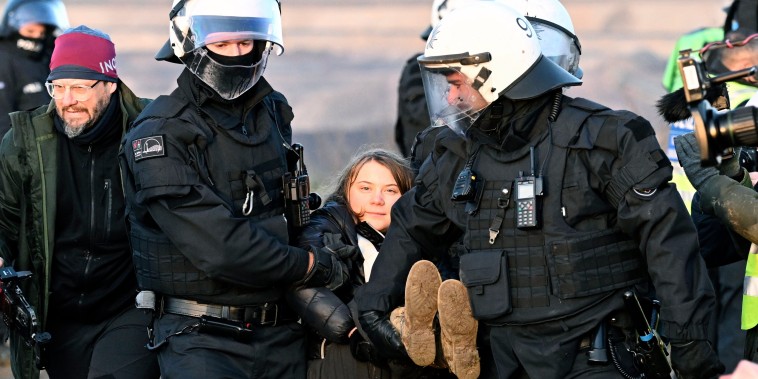 Police officers carry Swedish climate activist Greta Thunberg away from a mine during a protest by climate activists in Luetzerath, Germany, on Jan. 17, 2023. 