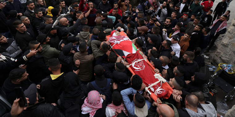 The body of Amr Khamour, 14, is carried during his funeral on Jan. 16.