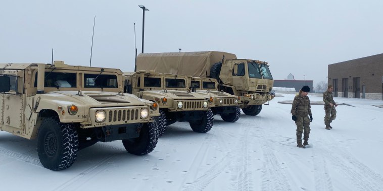 Soldiers from the 142nd Field Artillery Brigade in Lowell, Ark., prepare as inclement weather bears down on the region on Jan. 30, 2023.