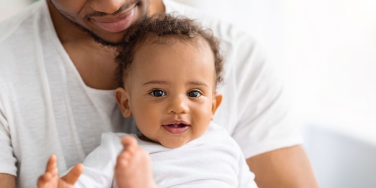Portrait Of Adorable Black Baby Boy Spending Time With Father At Home