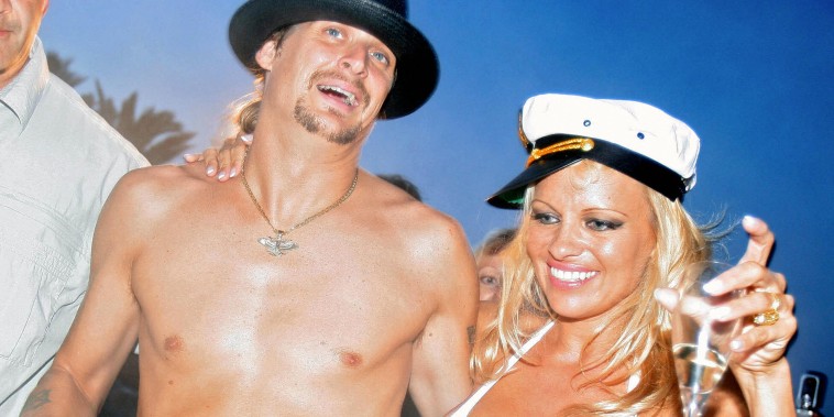 Pamela Anderson (R) shares a drink with her husband, US musician Kid Rock (C), the day of their wedding, on Pampelone's beach in Saint-Tropez, Southern France, 29 July 2006. Anderson, 39, married Rock, 35, aboard a yacht.