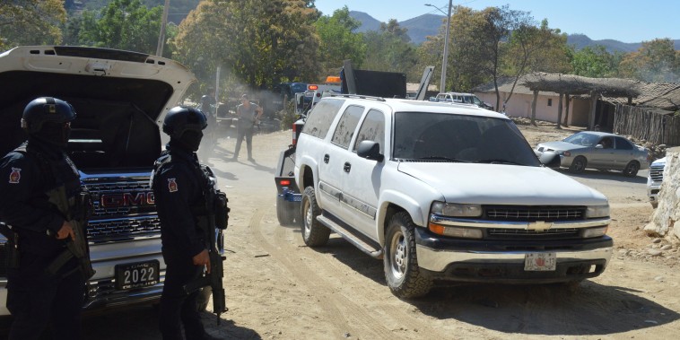 Members of the Sinaloa state police remove abandoned vehicles from the roads of Jesus Maria, Mexico, on Saturday, Jan. 7, 2023, the small town where Ovidio Guzman was detained earlier in the week. Thursday's government operation to detain Ovidio, the son of imprisoned drug lord Joaquin "El Chapo" Guzman, unleashed firefights that killed 10 military personnel and 19 suspected members of the Sinaloa drug cartel, according to authorities. 