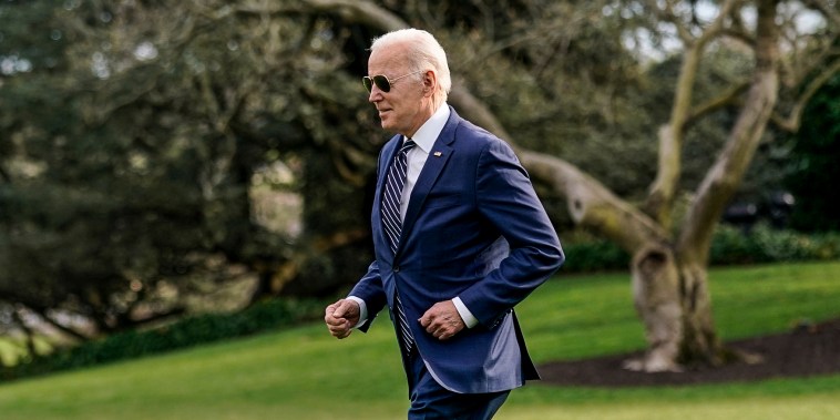 President Joe Biden jogs across the South Lawn of the White House to speak with visitors before boarding Marine One, on March 18, 2022.