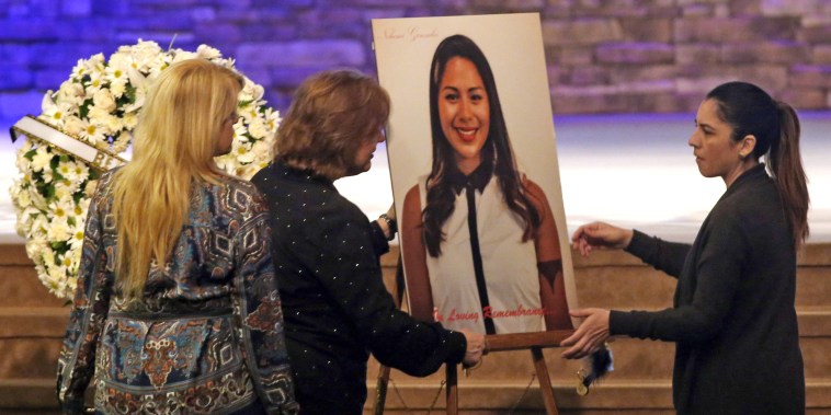 Women set up a picture of Paris attack victim Nohemi Gonzalez for her funeral service at the Calvary Chapel in Downey, Calif., on Dec. 4, 2015. 