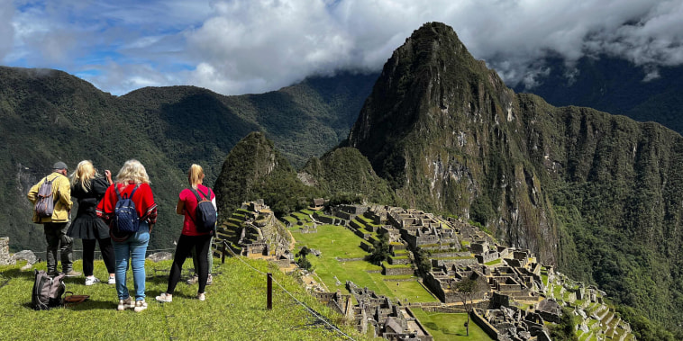 Tourists visit the ancient Inca ruins of Machu Picchu in the Urubamba valley, near cusco, Peru