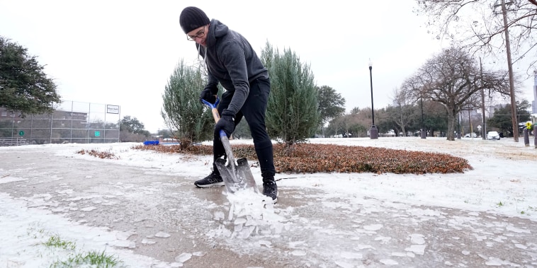 Joshua Lang retira nieve de una acera en el parque de un vecindario cerca de su casa en Dallas, el miércoles 1 de febrero de 2023.