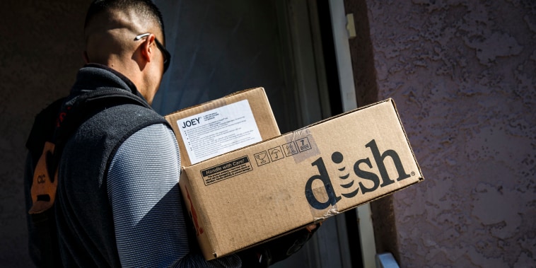 A Dish Network Corp. field service specialist during an installation of a satellite television system at a residence in Paramount, Calif., on Nov. 3, 2015.
