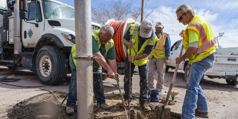 City workers repair a pipe that broke in Truth or Consequences, New Mexico