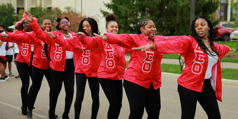 Members of Delta Sigma Theta sorority dance during the Indiana University Homecoming Parade in Bloomington, Ind.
