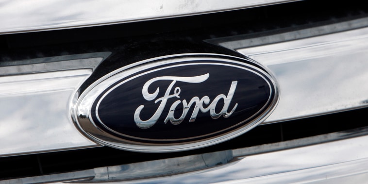 A Ford logo shines off the grille of a vehicle