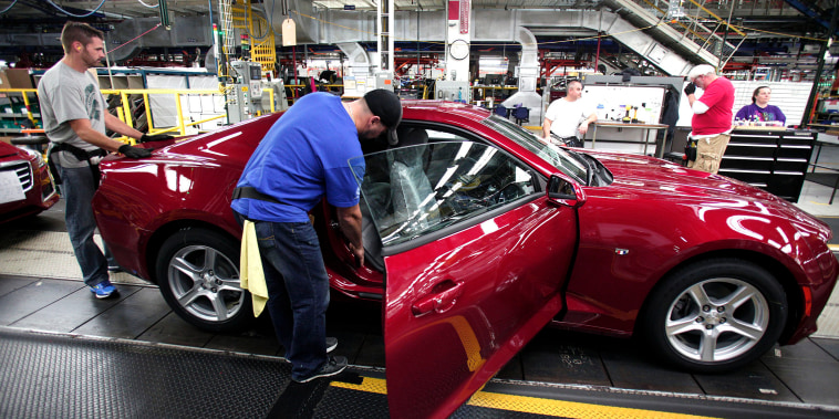 Workers put the finishing touches on a new General Motors 2016 Chevrolet Camaro as it rolls off the production line at GM's Lansing Grand River Assembly Plant October 26, 2015 in Lansing, Michigan. The Gen Six Camaro is the first to be produced in the United States since the third generation Camaro in 1992.