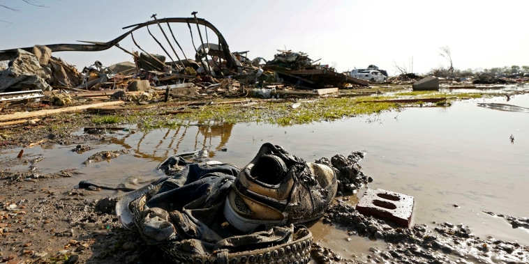 A pair of sneakers and pants lay in front of the skeletal remains of the underside of a mobile home in Rolling Fork, Miss., Saturday,  March 25, 2023.  Emergency officials in Mississippi say several people have been killed by tornadoes that tore through the state on Friday night, destroying buildings and knocking out power as severe weather produced hail the size of golf balls moved through several southern states. (AP Photo/Rogelio V. Solis)
