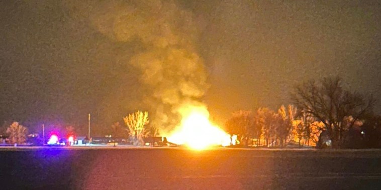 A resident in the area shared a photo of the fiery derailment saying they were awoken and evacuated by the Raymond Fire Department early Thursday.