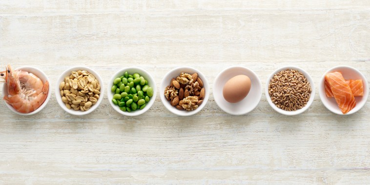 Allergenic foods in bowls - shellfish, nuts, soybeans, eggs, wheat, fish.