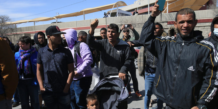 Un grupo de migrantes y familiares de personas fallecidas por un incendio protestan frente al INM, en Ciudad Juárez, México. 