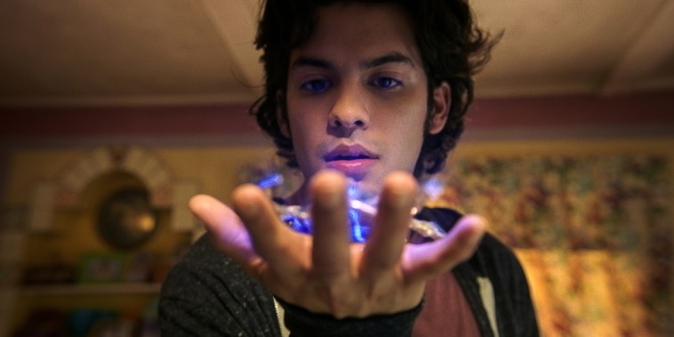 Xolo Maridueña as Jaime Reyes, with an ancient alien artifact known as the Scarab.