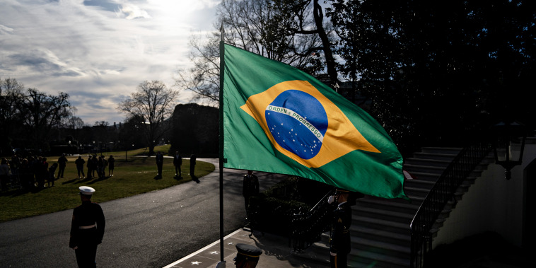 An honor guard holds Brazilian flag before President Joe Biden's meeting with Brazilian President Luiz Inacio Lula da Silva in Washington on Feb. 10, 2023.
