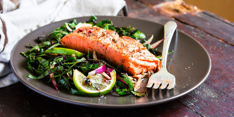 Salmon on a bed of salad.