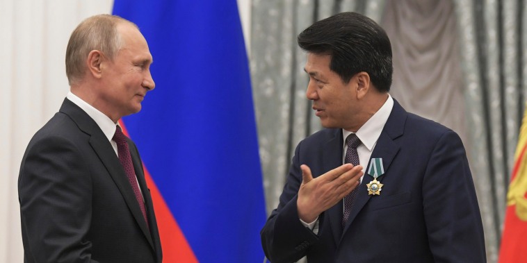 Russian President Vladimir Putin presents a state award to Li Hui at the Kremlin