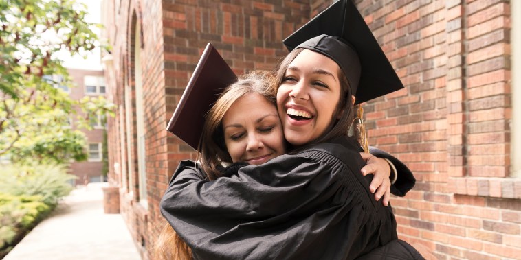 Happy American Mother Hugs Daughter Celebrating Graduation Day USA