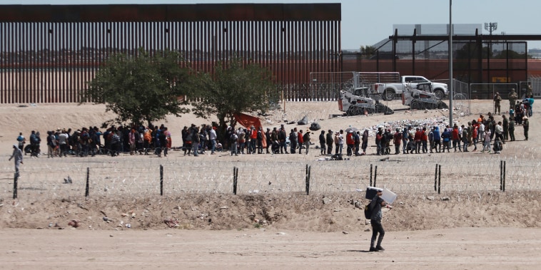 Migrants line up after being detained by US authorities at the US-Mexico border in Ciudad Juárez, Mexico on April 30, 2023. 