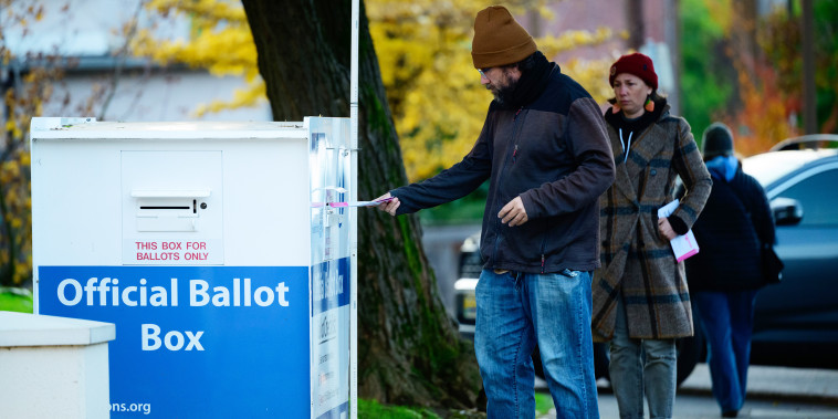 Voters cast their ballots at official ballot boxes during midterm elections on Nov. 8, 2022 in Portland, Ore.
